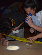 Students process a staged crime scene at NYLF Explore STEM